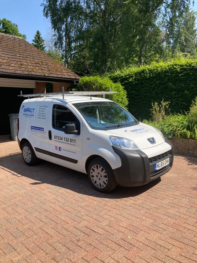 a white van parked in a driveway - exterior cleaning services, professional cleaning, roof cleaning,